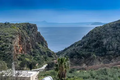 a view of a canyon with the ocean in the background at Chrispa's House in Chania Town