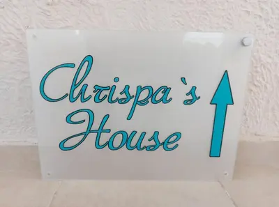 a sign for a chicago house with an arrow at Chrispa's House in Chania Town