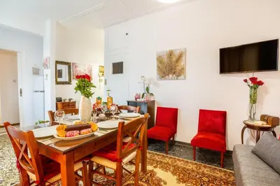 a dining room with a table and red chairs at Katerina's Apartment in Chania Center in Chania Town