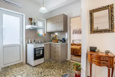 a kitchen with a white stove top oven next to a door at Katerina's Apartment in Chania Center in Chania Town