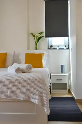 a bedroom with a bed with towels on it at Chania Sweet Apts in Chania Town