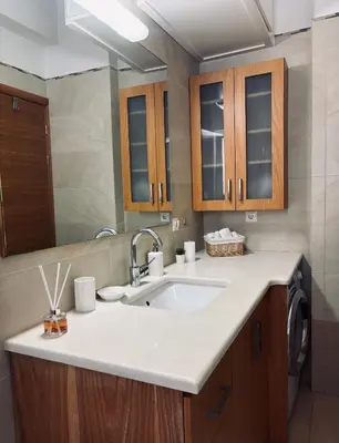 a bathroom with a sink and a mirror at Chania Sweet Apts in Chania Town