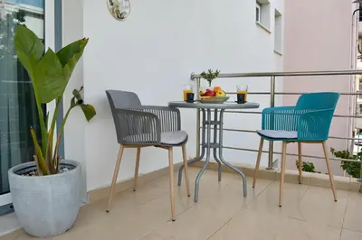 a balcony with a table and chairs in a room at Chania Sweet Apts in Chania Town