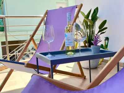 a table with a bottle of wine and two glasses at Chania Sweet Apts in Chania Town