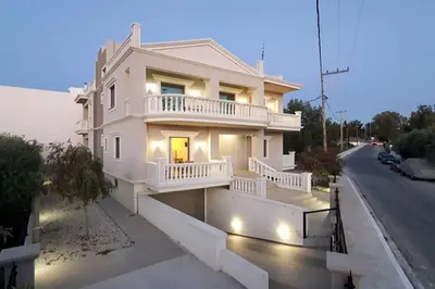 a white house with a balcony on a street at Olivia in Chania Town