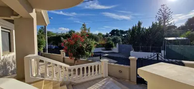 a balcony with a white fence and a tree at Olivia in Chania Town