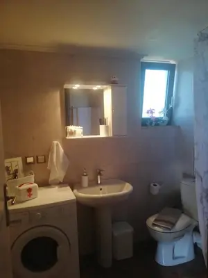a bathroom with a sink and a toilet and a mirror at Olivia in Chania Town