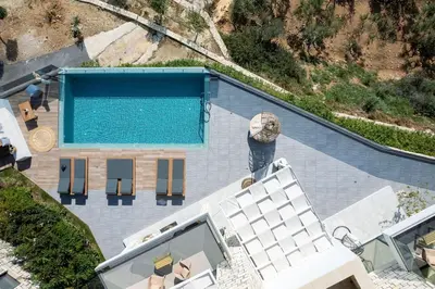 an overhead view of a swimming pool next to a house at Argyrie Villas, luxury, amazing sea view, heated pool in Kalleryianá