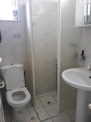 a bathroom with a shower and a toilet and a sink at Angel Villa in Strovlés