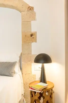a lamp on a table next to a bed at Casa Livieres in Chania Town