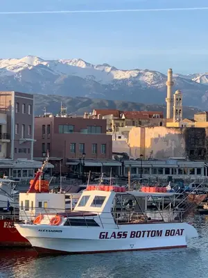 a boat is docked in the water near a city at Casa Livieres in Chania Town