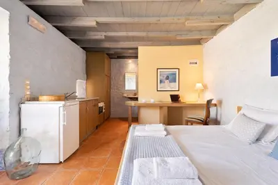 a bedroom with a bed and a desk in a room at Villa Mediterranea - Heated Pool optional in Livadia