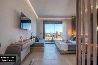 a bedroom with a bed and a balcony at Litinakis Studios Sea View & Litinakis Studios Garden View 700 meters away in Agia Marina Nea Kydonias