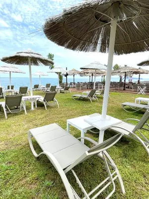 a group of chairs and umbrellas on the beach at Wave rooms in Maleme
