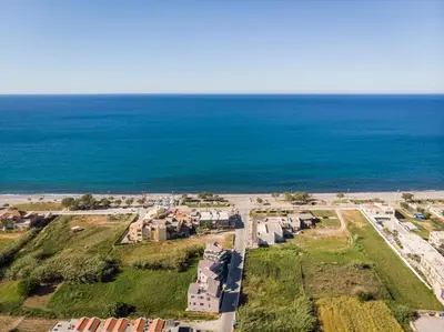 an aerial view of a resort near the ocean at Wave rooms in Maleme