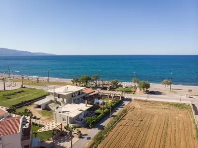 an aerial view of the beach and a resort at Wave rooms in Maleme