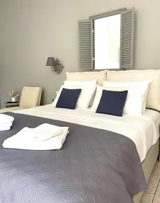 a large bed with blue pillows in a bedroom at Wave rooms in Maleme