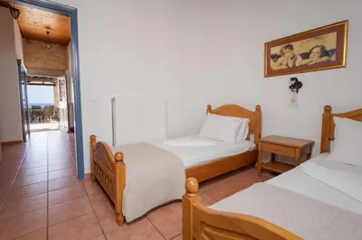 a bedroom with two beds and a balcony at Villa Anastasia Kalyves in Kalyves