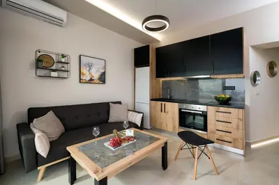 a living room with a couch and a table at Just Creta Sea View apartment in Chania Town