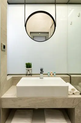 a bathroom with a white sink and a mirror at Just Creta Sea View apartment in Chania Town