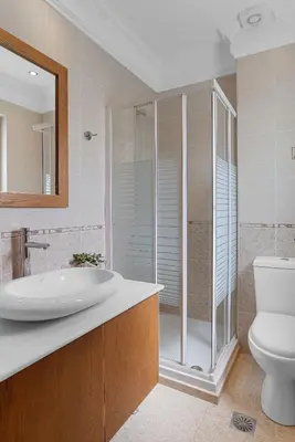 a bathroom with a shower and a sink and a toilet at Amphitrite Beach House in Chania Town