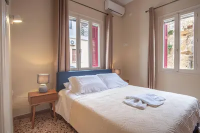 a bedroom with a bed with two towels on it at 4 Guests - Veneris Residence Apartment in Chania in Chania Town