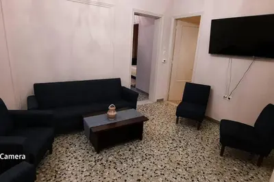 a living room with a couch and chairs and a tv at 4 Guests - Veneris Residence Apartment in Chania in Chania Town