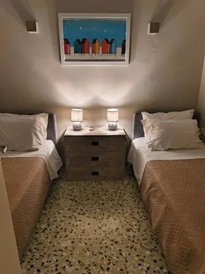 a bedroom with two beds and a dresser with two lamps at 4 Guests - Veneris Residence Apartment in Chania in Chania Town