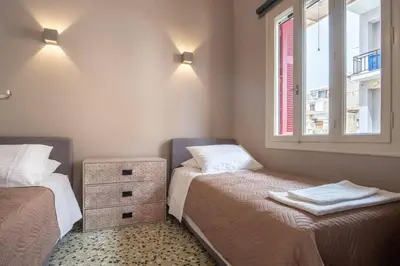 a small room with two beds and a window at 4 Guests - Veneris Residence Apartment in Chania in Chania Town