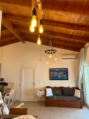 a living room with a couch and wooden ceilings at House Gylisma in Kámbos