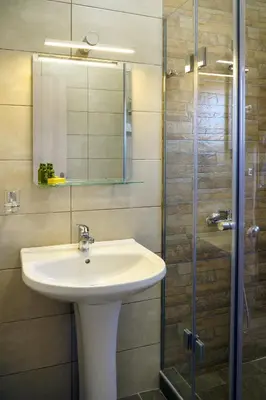 a bathroom with a sink and a glass shower at RODOU Suites & Villas in Chania Town