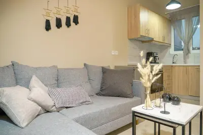 a living room with a gray couch and a table at RODOU Suites & Villas in Chania Town
