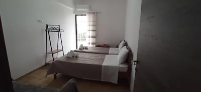 a bedroom with two beds and a window at GS Lumen Apartment in Chania Town