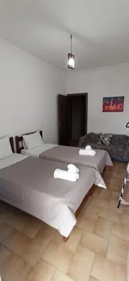 a bedroom with two beds with towels on them at GS Lumen Apartment in Chania Town