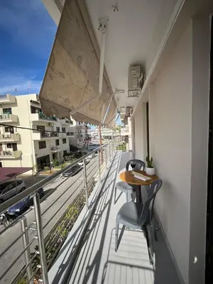a balcony with a table and chairs on a building at GS Lumen Apartment in Chania Town
