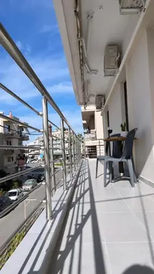 a balcony with a table and chairs on a building at GS Lumen Apartment in Chania Town