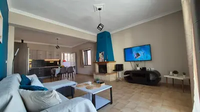 a living room with a couch and a fireplace at GS Lumen Apartment in Chania Town