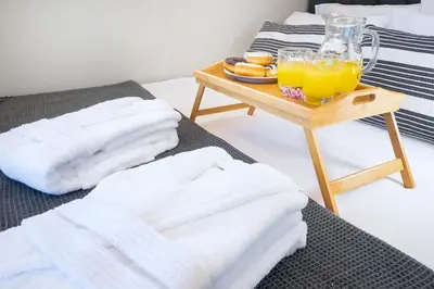 a table with towels and a tray of orange juice at MM Villa in Chania Town