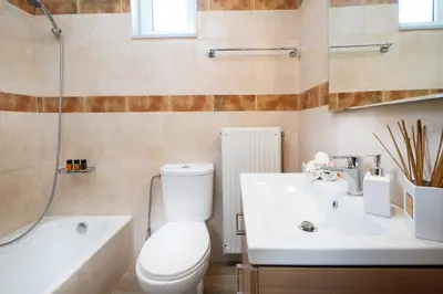 a bathroom with a toilet and a sink and a bath tub at MM Villa in Chania Town