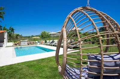 a swing in a yard next to a swimming pool at MM Villa in Chania Town