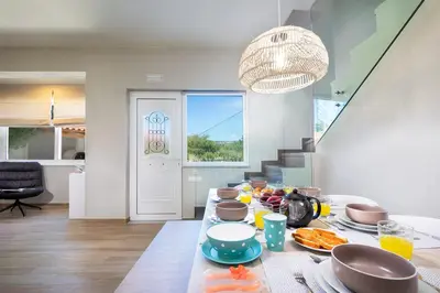 a dining room with a table with food on it at MM Villa in Chania Town