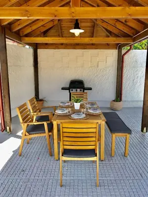 a table and chairs on a patio with a stove at Villa Elena - Private Villa in the heart of nature in Chania Town
