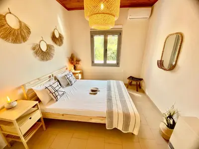a bedroom with a large bed in a room at Villa Elena - Private Villa in the heart of nature in Chania Town