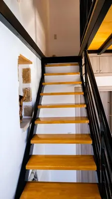 a staircase in a house with white walls and wooden steps at VAMA APARTMENT in Plataniás