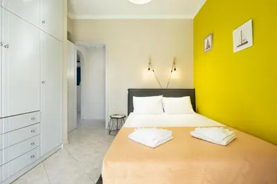 a bedroom with a large bed with a yellow wall at Casa Regno in Ayiá