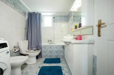 a bathroom with a white toilet and a sink at Casa Regno in Ayiá