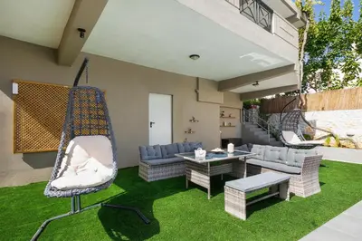 a backyard with a hammock and a patio at Casa Regno in Ayiá