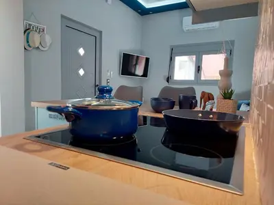 a kitchen with a large blue pot on a stove at Royal Legend Suite in Souda