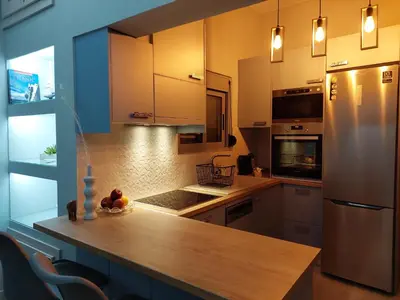 a kitchen with a wooden counter and a refrigerator at Royal Legend Suite in Souda