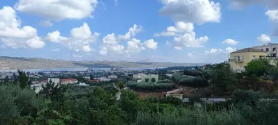 a view of a city with a lake and buildings at Royal Legend Suite in Souda